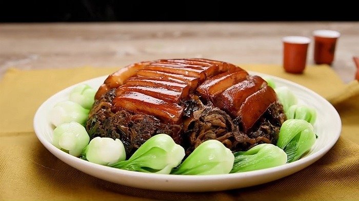Món thịt kho tàu hấp dẫn trên đĩa, kết hợp cải xanh tươi và nước sốt nâu bóng, kèm bối cảnh ẩm thực Trung Hoa.